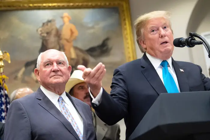 Secretary of Agriculture Sonny Perdue (left) and Trump at a press conference on farmers earlier this year